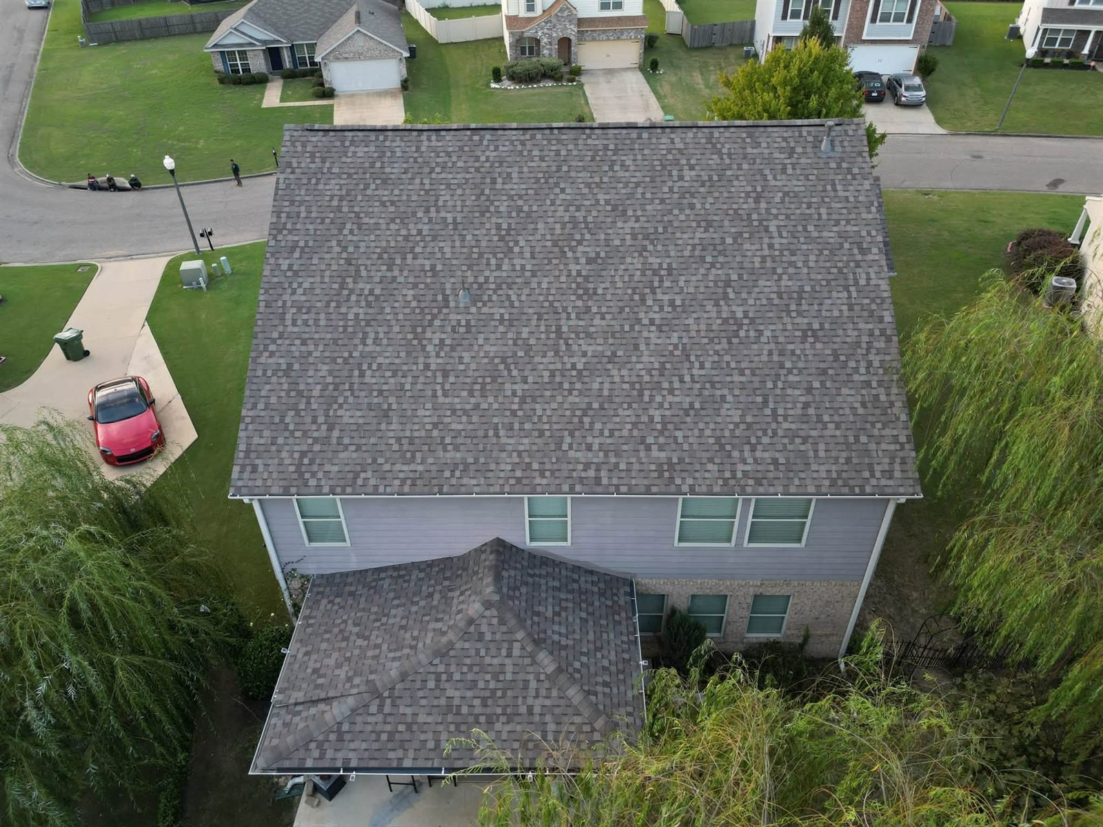 Two-story home with a new shingle roof, roof edge and fascia in view